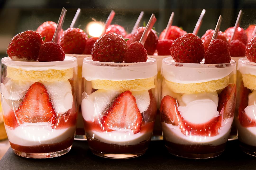 Elegant dessert bar setup with pastries and mini cakes