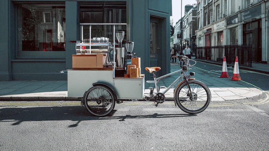 Compact silver mobile coffee bike at a market event