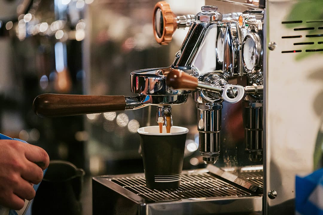 Mobile coffee cart setup with branded signage at a corporate event
