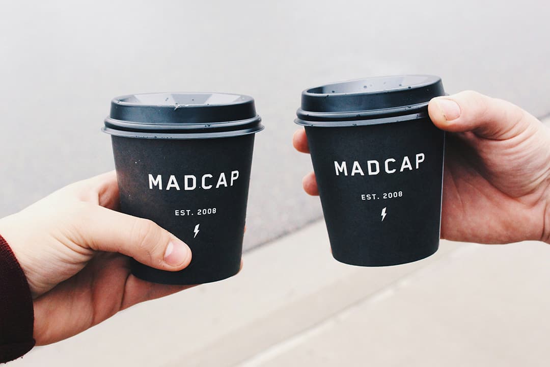 Custom branded coffee cups at an event