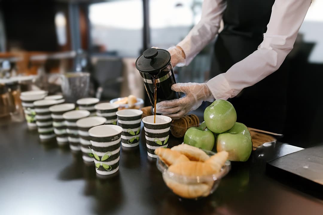 Professional barista preparing espresso in a corporate office